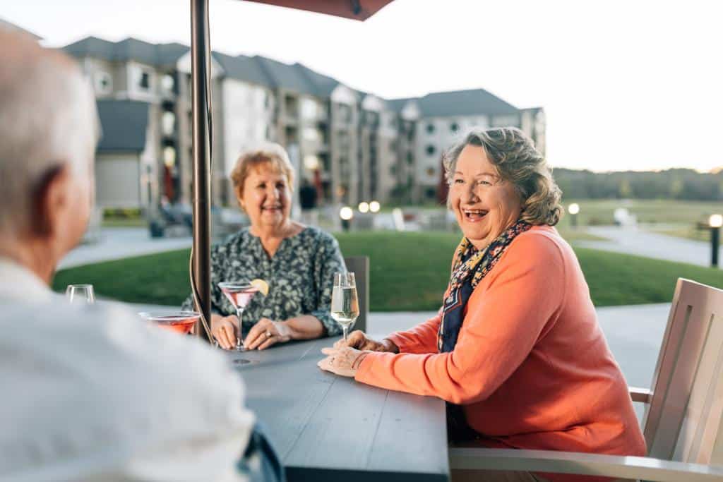 friends sharing a drink and some laughs on the patio