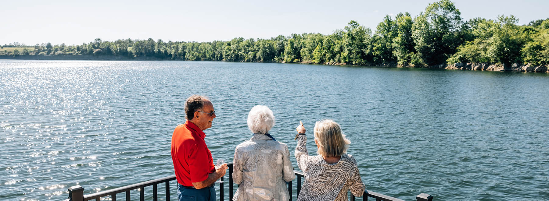 friends looking across the lake at The Spires