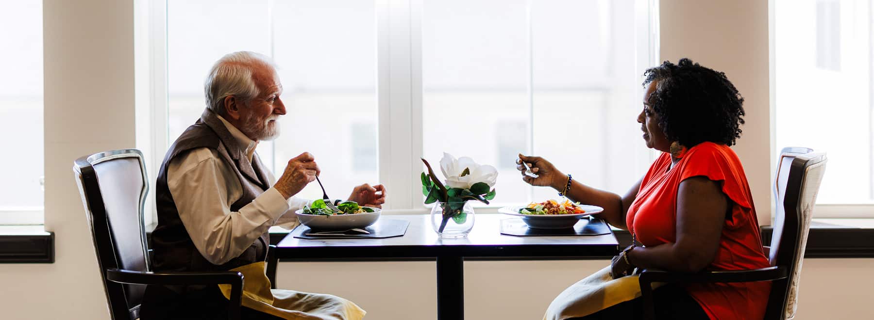 elderly couple having a conversation at dinner