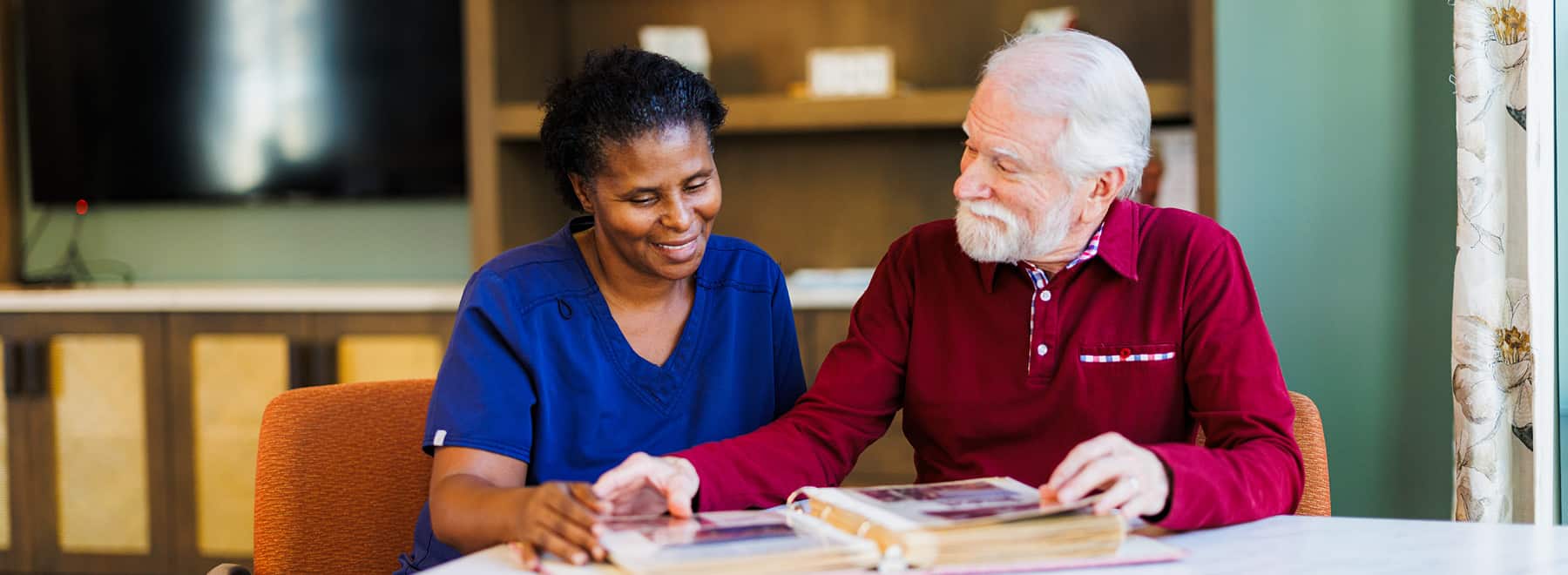 a man and women looking at a book together