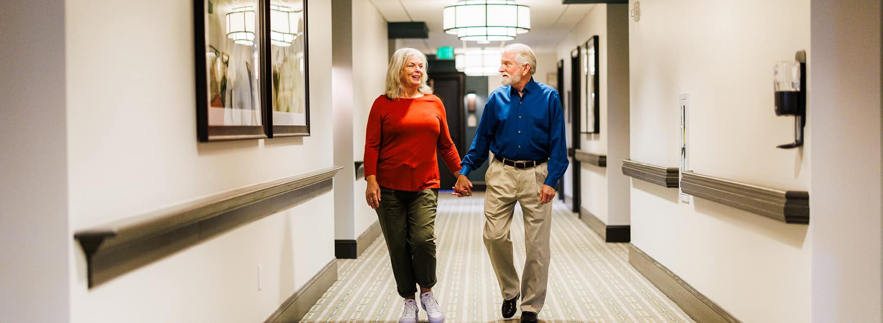 elderly couple holding hands together
