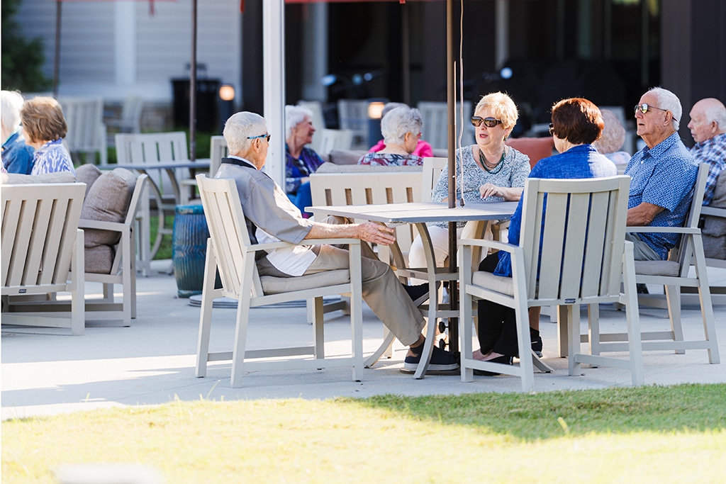 Group of elderly sitting outsit on a patio
