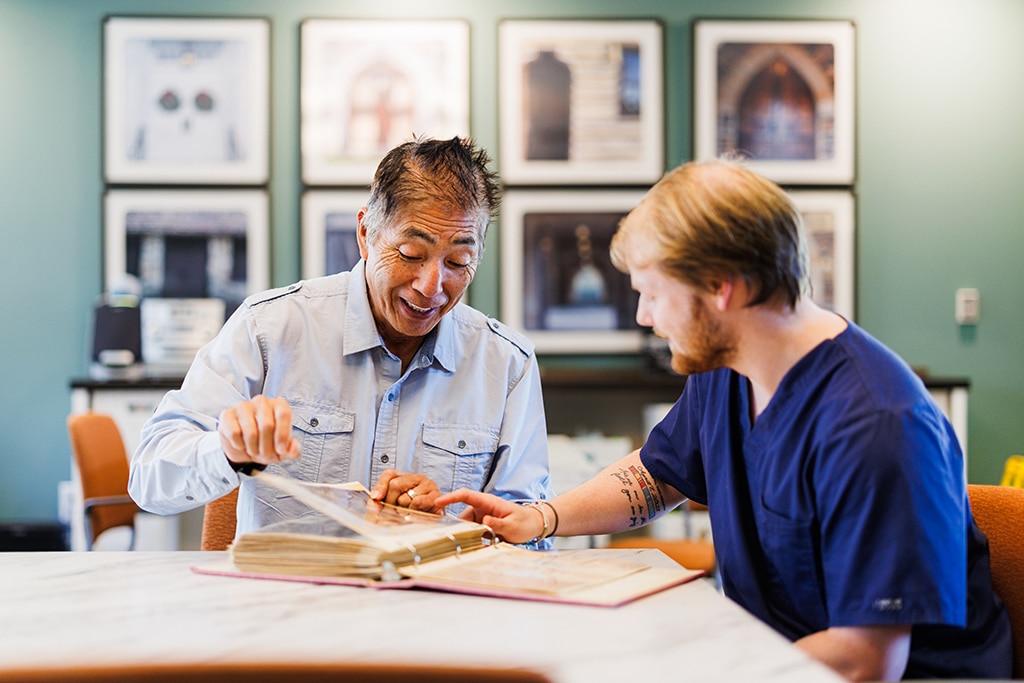 two men looking through a book together