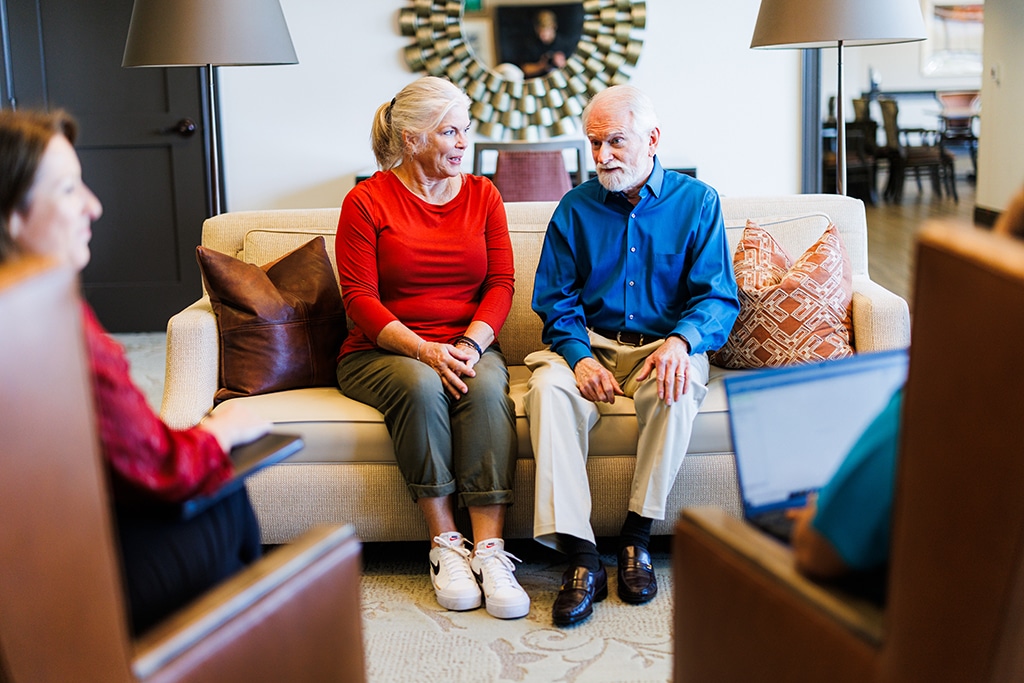 elderly couple sitting on a couch together