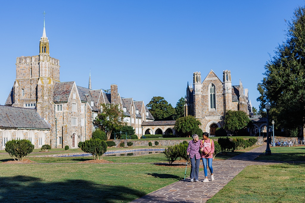 two women walking through a park