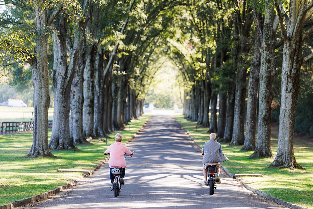 elderly couple riding bikes together