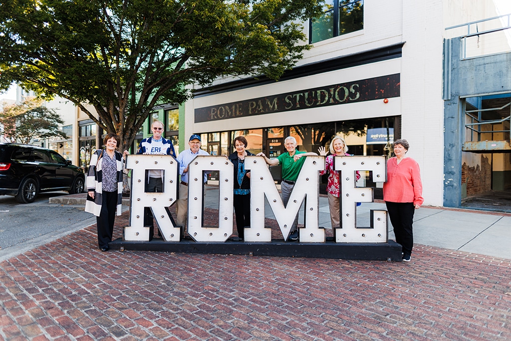 people standing in front of giant sign